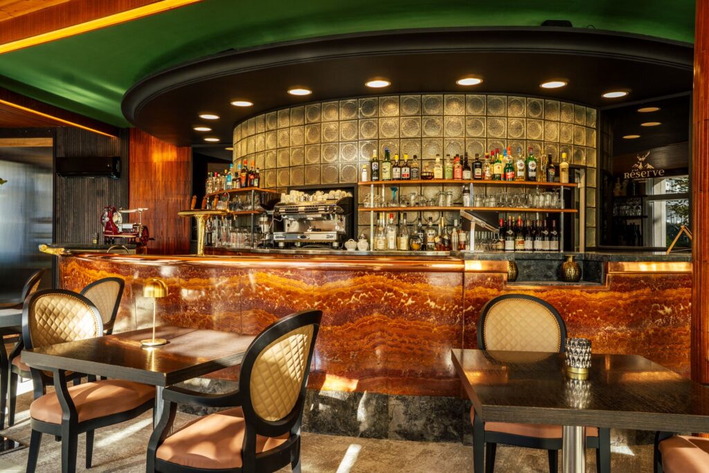 Lounge bar vintage avec comptoir en marbre et fauteuils, hôtel La Réserve Gérardmer