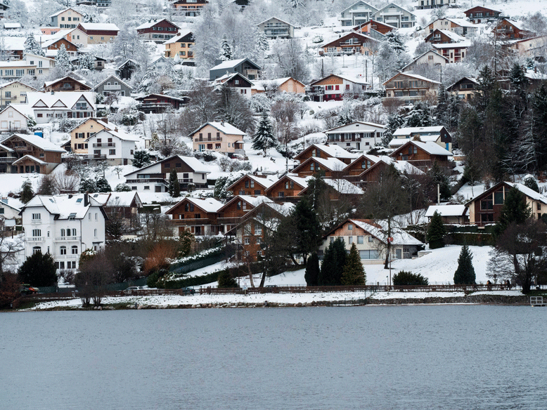 Gérardmer sous la neige, chalets au bord du lac en hiver